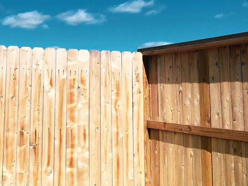 Example photo: wooden privacy fence under a blue sky